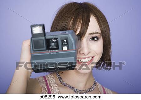 Portrait of a teenage girl looking through a camera View Large Photo Image Stock Photography - Portrait of a teenage girl looking through a camera. Fotosearch
