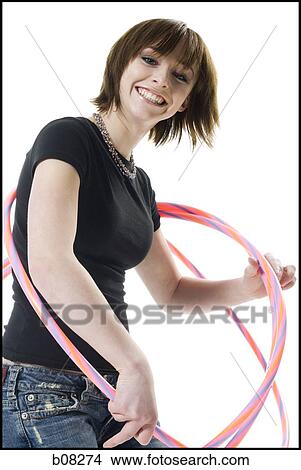 Portrait of a teenage girl playing with hula hoops View Large Photo Image Picture - Portrait of a teenage girl playing with hula hoops. Fotosearch