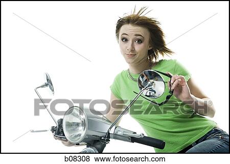Portrait of a teenage girl riding a scooter View Large Photo Image Stock Photo - Portrait of a teenage girl riding a scooter. Fotosearch