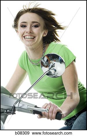 Portrait of a teenage girl riding a scooter View Large Photo Image Stock Photo - Portrait of a teenage girl riding a scooter. Fotosearch