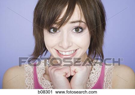Portrait of a teenage girl smiling with her hands on her chin View Large Photo Image Stock Image - Portrait of a teenage girl smiling with her hands on her chin. Fotosearch