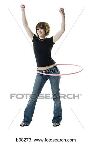 Portrait of a teenage girl spinning a hula hoop around her waist View Large Photo Image Stock Image - Portrait of a teenage girl spinning a hula hoop around her waist. Fotosearch
