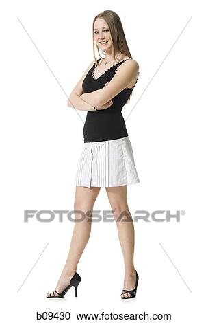 Stock Image - Portrait of a teenage girl standing with her arms crossed. Fotosearch