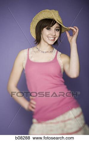 Stock Photo - Portrait of a teenage girl standing with her hand on her hip. Fotosearch