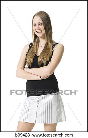 Portrait of a teenage girl standing with her arms crossed View Large Photo Image Stock Photo - Portrait of a teenage girl standing with her arms crossed. Fotosearch