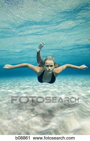 Portrait of a teenage girl swimming underwater View Large Photo Image Stock Image - Portrait of a teenage girl swimming underwater. Fotosearch
