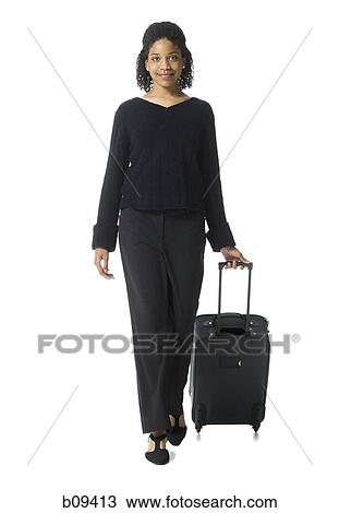 Portrait of a teenage girl walking with luggage View Large Photo Image Stock Image - Portrait of a teenage girl walking with luggage. Fotosearch