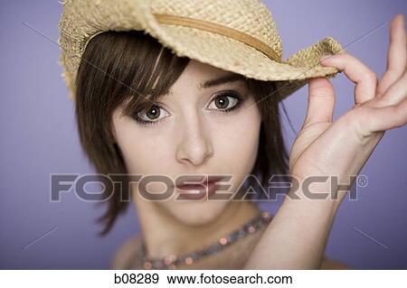 Portrait of a teenage girl wearing a straw hat View Large Photo Image Stock Photo - Portrait of a teenage girl wearing a straw hat. Fotosearch