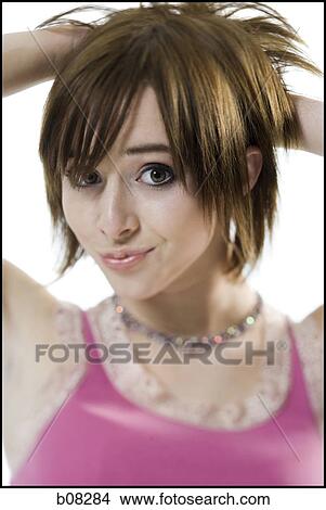 Portrait of a teenage girl with her hands behind her head View Large Photo Image Picture - Portrait of a teenage girl with her hands behind her head. Fotosearch