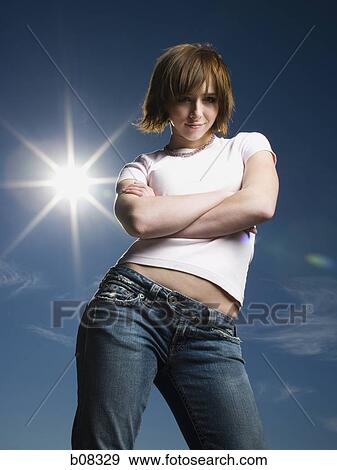 Portrait of a teenage girl with her arms crossed View Large Photo Image Stock Photo - Portrait of a teenage girl with her arms crossed. Fotosearch