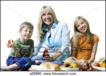 Portrait of a woman and her two children having a picnic View Large Photo Image Stock Image - Portrait of a woman and her two children having a picnic. Fotosearch