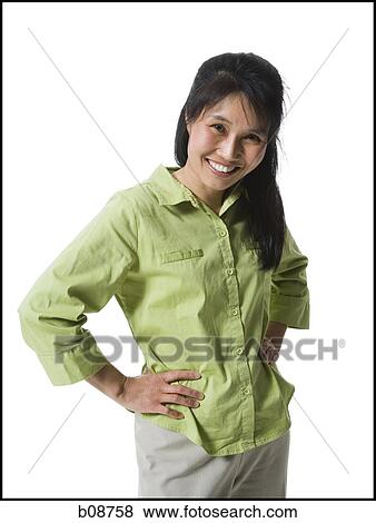 Portrait of a woman standing with hands on hips View Large Photo Image Stock Photo - Portrait of a woman standing with hands on hips. Fotosearch