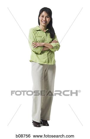 Portrait of a woman standing with her arms folded and smiling View Large Photo Image Stock Photograph - Portrait of a woman standing with her arms folded and smiling. Fotosearch