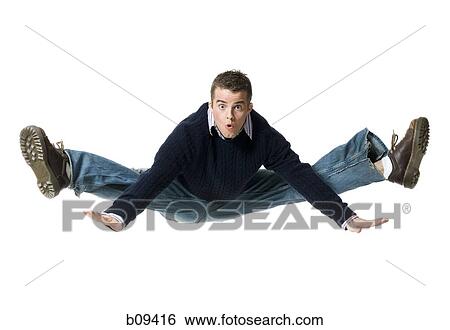 Portrait of a young man jumping in mid air View Large Photo Image Stock Photograph - Portrait of a young man jumping in mid air. Fotosearch