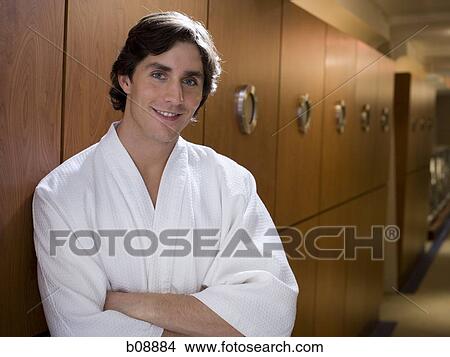 Portrait of a young man leaning against a wooden wall with his arms crossed View Large Photo Image Picture - Portrait of a young man leaning against a wooden wall with his arms crossed. Fotosearch