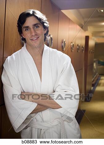 Portrait of a young man leaning against a wooden wall with his arms crossed View Large Photo Image Stock Image - Portrait of a young man leaning against a wooden wall with his arms crossed. Fotosearch