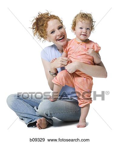 Stock Photo - Portrait of a young woman and her daughter smiling. Fotosearch