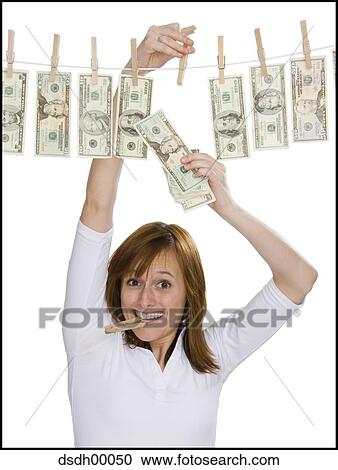 Portrait of a young woman drying dollar bills on a clothesline View Large Photo Image Stock Image - Portrait of a young woman drying dollar bills on a clothesline. Fotosearch