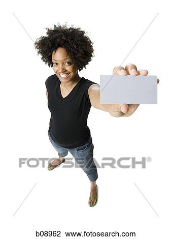 Portrait of a young woman holding a blank sign View Large Photo Image Stock Image - Portrait of a young woman holding a blank sign. Fotosearch
