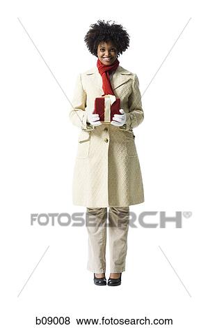 Portrait of a young woman holding a gift box View Large Photo Image Stock Photo - Portrait of a young woman holding a gift box. Fotosearch