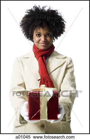 Portrait of a young woman holding a gift box View Large Photo Image Stock Photography - Portrait of a young woman holding a gift box. Fotosearch