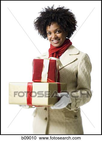Portrait of a young woman holding gift boxes View Large Photo Image Stock Image - Portrait of a young woman holding gift boxes. Fotosearch