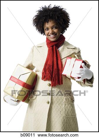 Portrait of a young woman holding gift boxes View Large Photo Image Stock Image - Portrait of a young woman holding gift boxes. Fotosearch
