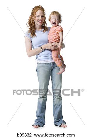 Portrait of a young woman holding her daughter View Large Photo Image Stock Image - Portrait of a young woman holding her daughter. Fotosearch