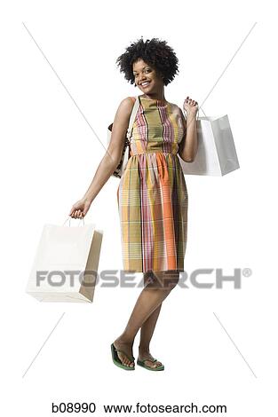 Portrait of a young woman holding shopping bags View Large Photo Image Stock Image - Portrait of a young woman holding shopping bags. Fotosearch