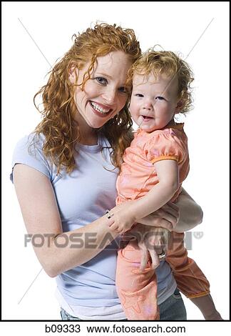 Portrait of a young woman hugging her daughter View Large Photo Image Stock Image - Portrait of a young woman hugging her daughter. Fotosearch