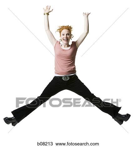 Portrait of a young woman jumping in mid-air with arms raised View Large Photo Image Stock Image - Portrait of a young woman jumping in mid-air with arms raised. Fotosearch
