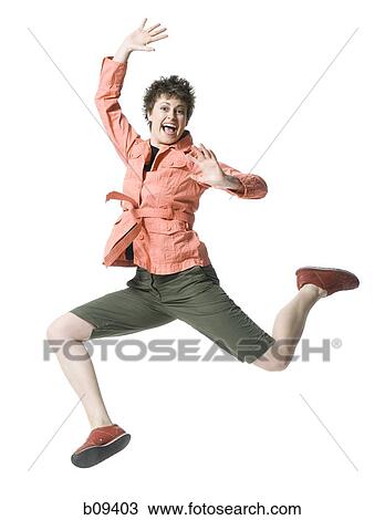 Portrait of a young woman jumping in mid air View Large Photo Image Stock Image - Portrait of a young woman jumping in mid air. Fotosearch