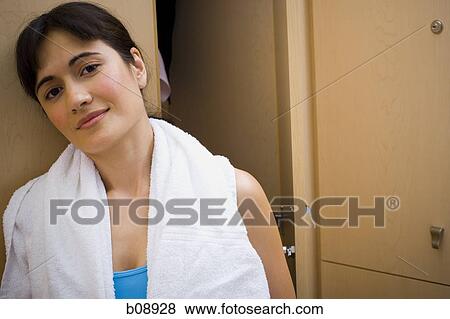 Portrait of a young woman leaning against a closet View Large Photo Image Stock Photo - Portrait of a young woman leaning against a closet. Fotosearch