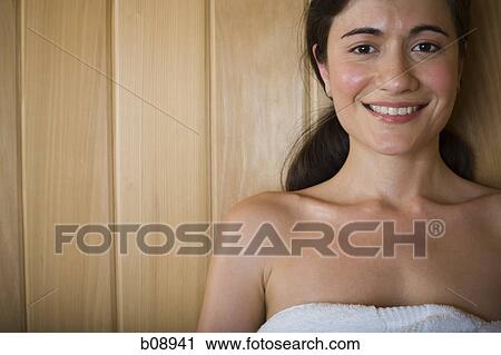 Portrait of a young woman smiling and relaxing in a sauna View Large Photo Image Stock Image - Portrait of a young woman smiling and relaxing in a sauna. Fotosearch