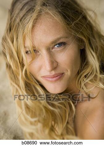 Stock Image - Portrait of a young woman smiling. Fotosearch