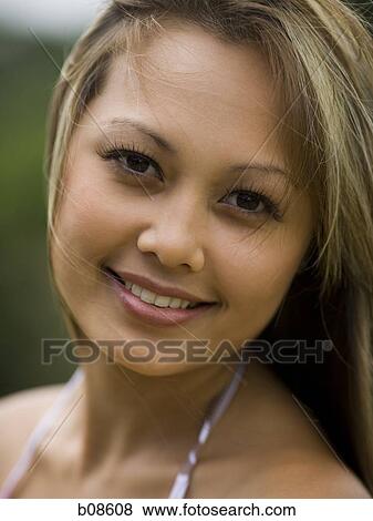 Portrait of a young woman smiling View Large Photo Image Stock Photo - Portrait of a young woman smiling. Fotosearch