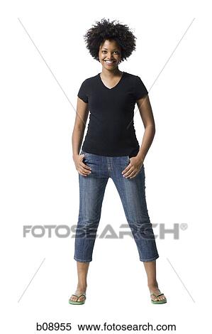 Portrait of a young woman smiling with her hands in her pockets View Large Photo Image Stock Photography - Portrait of a young woman smiling with her hands in her pockets. Fotosearch