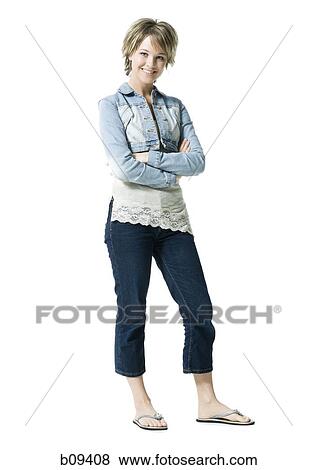 Portrait of a young woman standing and smiling View Large Photo Image Stock Photo - Portrait of a young woman standing and smiling. Fotosearch