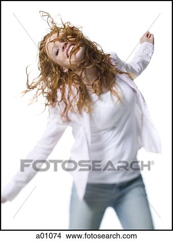 Portrait of a young woman standing with her arm outstretched View Large Photo Image Picture - Portrait of a young woman standing with her arm outstretched. Fotosearch