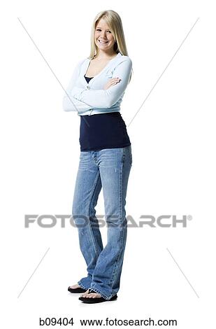 Portrait of a young woman standing with her arms crossed View Large Photo Image Picture - Portrait of a young woman standing with her arms crossed. Fotosearch