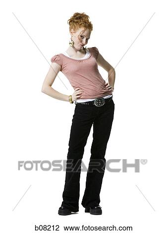 Portrait of a young woman standing with hands on hips View Large Photo Image Stock Image - Portrait of a young woman standing with hands on hips. Fotosearch