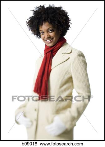 Portrait of a young woman standing with her hands in her pockets View Large Photo Image Stock Photography - Portrait of a young woman standing with her hands in her pockets. Fotosearch
