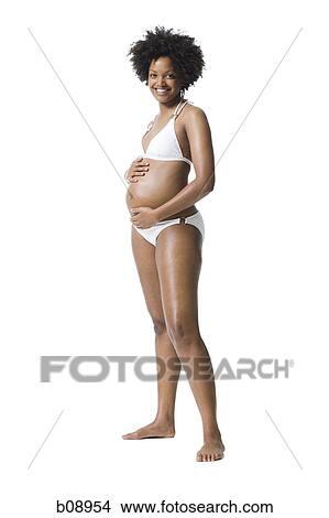 Portrait of a young woman touching her abdomen View Large Photo Image Picture - Portrait of a young woman touching her abdomen. Fotosearch