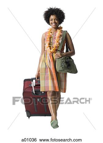 Portrait of a young woman walking with luggage View Large Photo Image Stock Photograph - Portrait of a young woman walking with luggage. Fotosearch