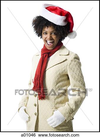 Portrait of a young woman wearing a Santa hat View Large Photo Image Stock Photograph - Portrait of a young woman wearing a Santa hat. Fotosearch
