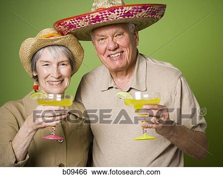Portrait of an elderly couple holding glasses of lemon juice View Large Photo Image Stock Photograph - Portrait of an elderly couple holding glasses of lemon juice. Fotosearch