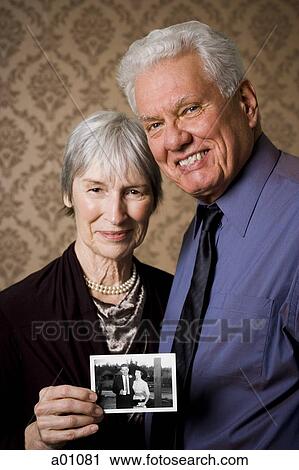 Portrait of an elderly couple showing a photograph View Large Photo Image Stock Image - Portrait of an elderly couple showing a photograph. Fotosearch