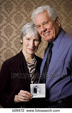 Portrait of an elderly couple showing a photograph View Large Photo Image Stock Image - Portrait of an elderly couple showing a photograph. Fotosearch