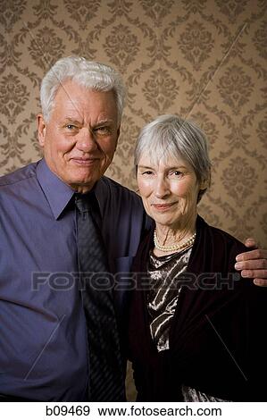 Portrait of an elderly couple standing together View Large Photo Image Stock Photo - Portrait of an elderly couple standing together. Fotosearch