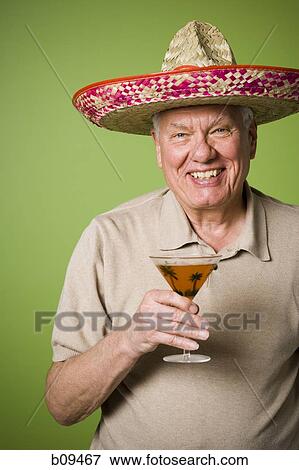 Portrait of an elderly man holding a glass View Large Photo Image Stock Photo - Portrait of an elderly man holding a glass. Fotosearch